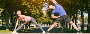 fit-fitness-woman-man-doing-stretching-exercises-outdoors-park